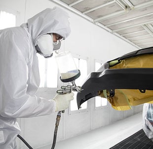 Collision Center Technician Painting a Vehicle | Toyota City in Mamaroneck NY